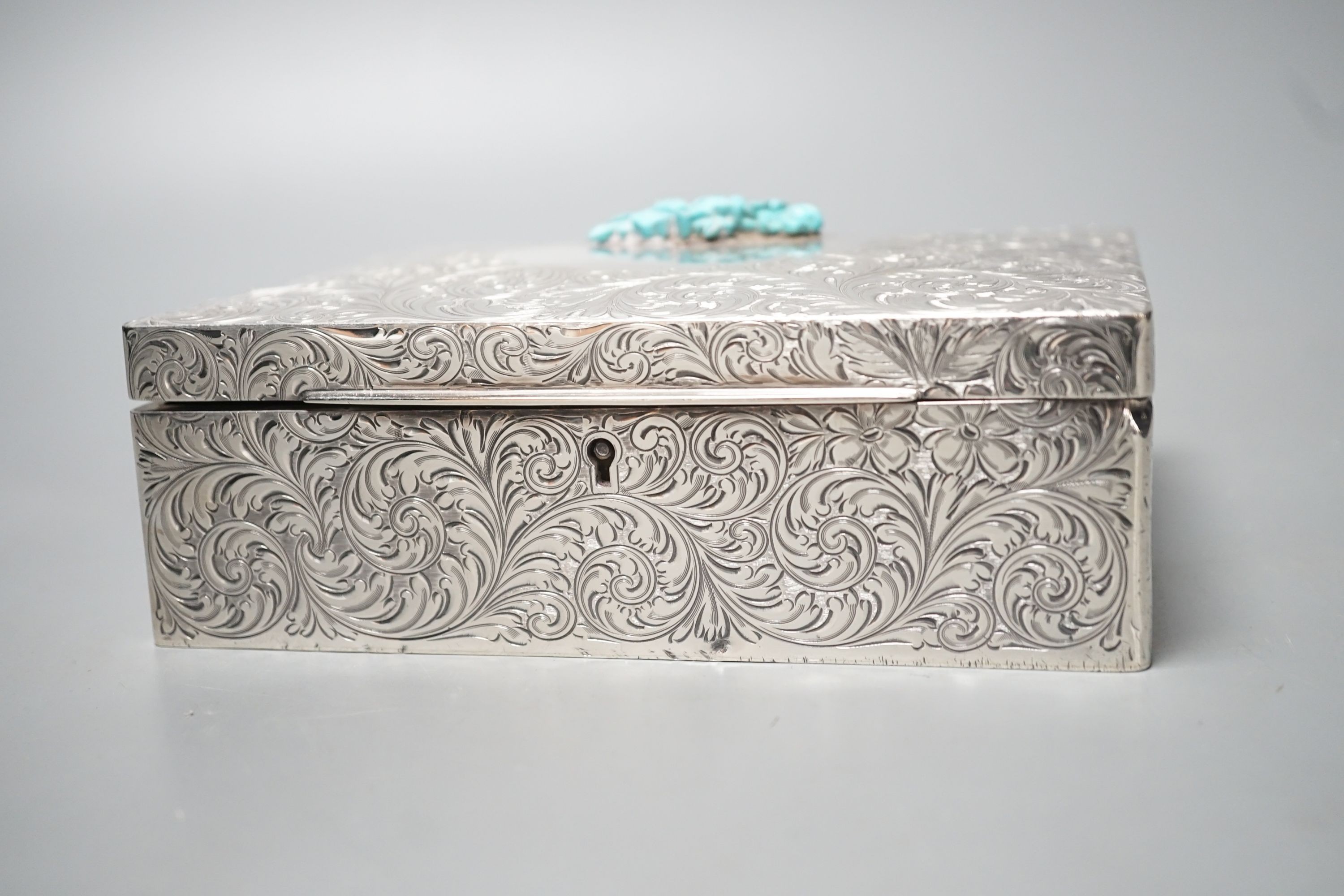 An engraved sterling rectangular box, with later added foliate mount, 16cm.